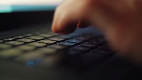 Man working on laptop computer in the dark in closeup 4k stock footage Stock Footage 168494263