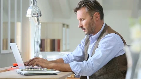 Man working on laptop computer Stock Footage 56056181