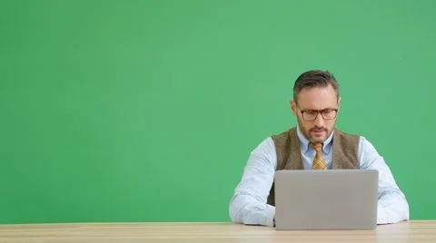 Man working on laptop computer, green screen Stock Footage 59756392