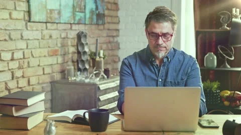 Man working with laptop computer at home office Stock Footage 132919317