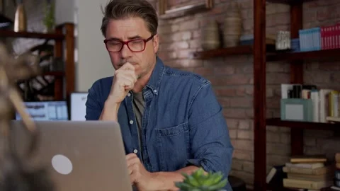 Man working with laptop computer at home office Stock Footage 148433961