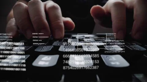 Man working on laptop computer keyboard with graphic user interface GUI hologram Stock Photos