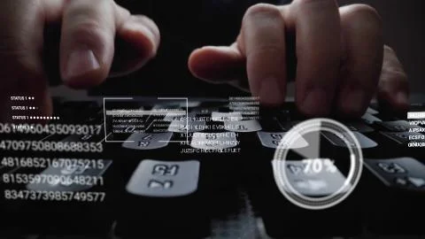 Man working on laptop computer keyboard with graphic user interface GUI hologram Stock Photos