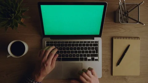Man working with laptop computer at night. Laptop with green screen. Top view  Stock Footage 75819917