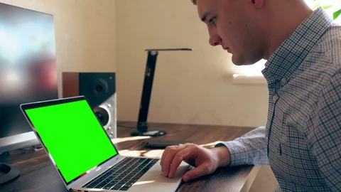 Man working on a laptop computer in an office Stock Footage 125896565