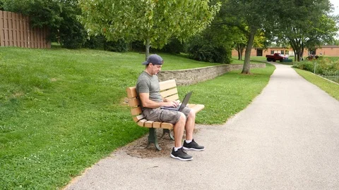 Man working on laptop computer outside thinking stressed, 4k, 60fps. Stock Footage 115900932