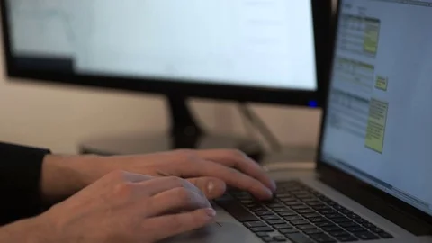 Man working on laptop at desk Stock Footage 75656996