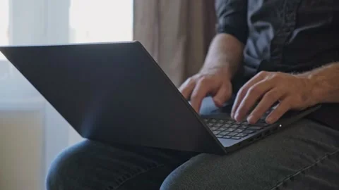Man working on the laptop from a different angle Stock Footage 163993592