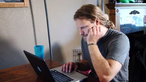 Man working at laptop in dining room Stock Footage 154762253
