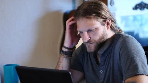 Man working at laptop in dining room Stock Footage 154762315