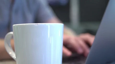 Man Working on Laptop Drinks Coffee 動画素材 83525292