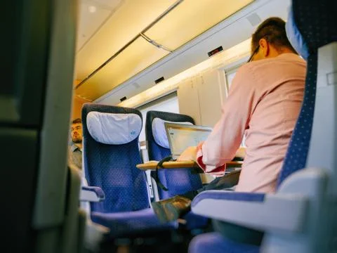 Man working on laptop in fast train Stock Photos
