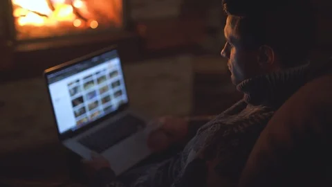 The man working with laptop by the fireplace Stock Footage 123160620