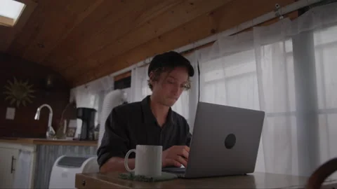 Man Working On Laptop In His Tiny House Stock Footage 219544362