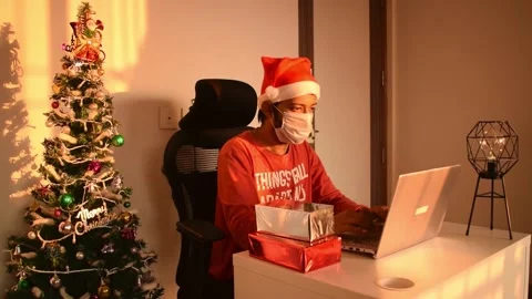 Man working on laptop from home on christmas holiday wearing mask in coronavirus Stock Footage 145532953