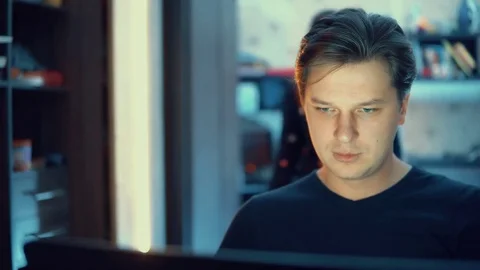 A man is working on a laptop at home. Stock Footage 84565713