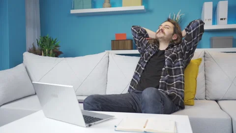 Man working on laptop at home. Happy and satisfied. Stock Footage 236333653