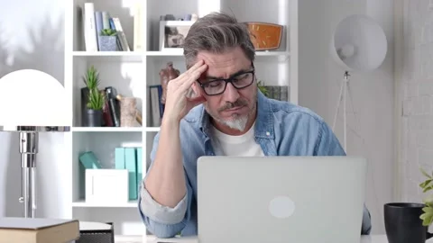 Man working with laptop at home office Stock Footage 148024372