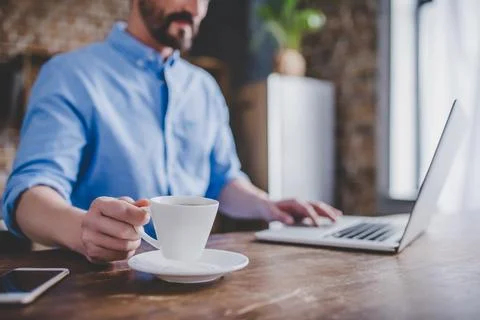 Man working on laptop at the kitchen Stock Photos