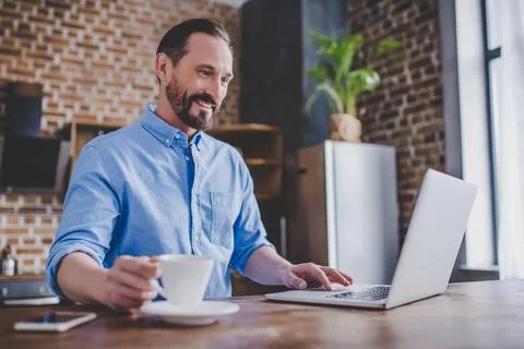 Man working on laptop at the kitchen Stock Photos