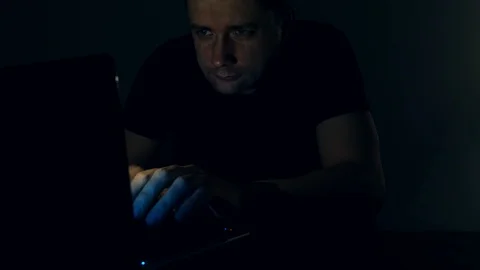 Man working with laptop at night. Programmer or hacker at work. Stock-Footage 87112741