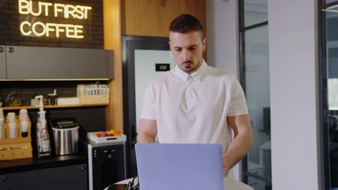 A man is working at a laptop in an office cafe. Office worker Stock Footage 201921634
