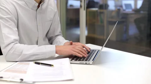 Man working on laptop in office, looking camera Stock Footage 43150108
