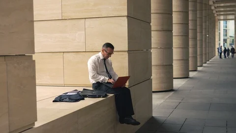 Man working on laptop outside Stock Footage 92065644