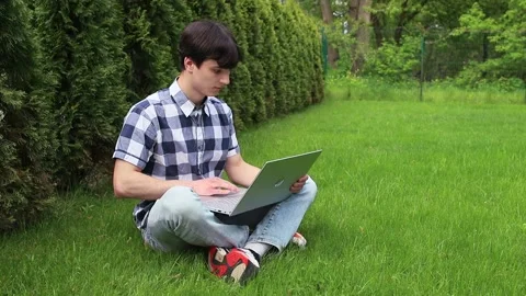 Man working with laptop in park Stock Footage 259564266