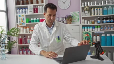 Man working with a laptop in a pharmacy surrounded by shelves filled with v.. Stock Footage 280325379