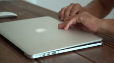 Man working with laptop placed on wooden desk Stock Footage 54032346
