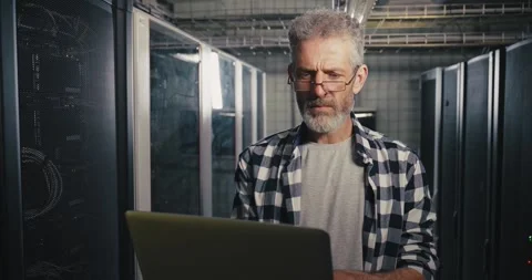 Man Working on Laptop in Server Room Stock Footage 275903683