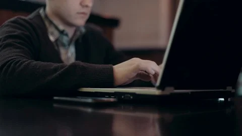 A man working at a laptop sitting in a cafe Video stock 71565489