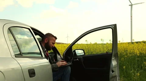 Man working at the laptop, sitting in car Stock Footage 62861582