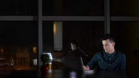 Man is working on a Laptop Sitting Next to Window HD Stock-Footage 92944414