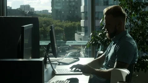 Man working on laptop sitting at table 動画素材 77279014