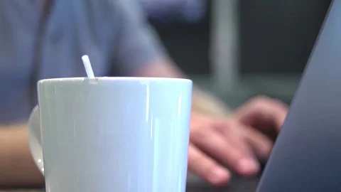 Man Working on Laptop Stirs Coffee Stock Footage 83525289