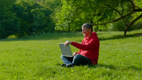 Man working on laptop in summer forest Stock Footage 155348235