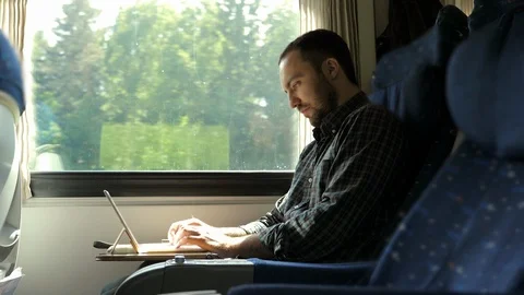 Man working on laptop tablet computer in train. Vídeos de archivo 113356348