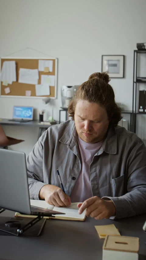Man Working on Laptop Taking Notes during Online Business Meeting Stock Footage 348147401