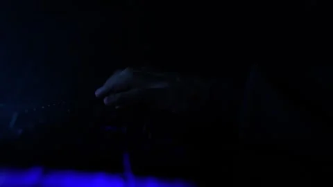Man Working on Laptop Typing Fast on Keyboard in Neon Lighting Police Flasher Stock Footage 253220455