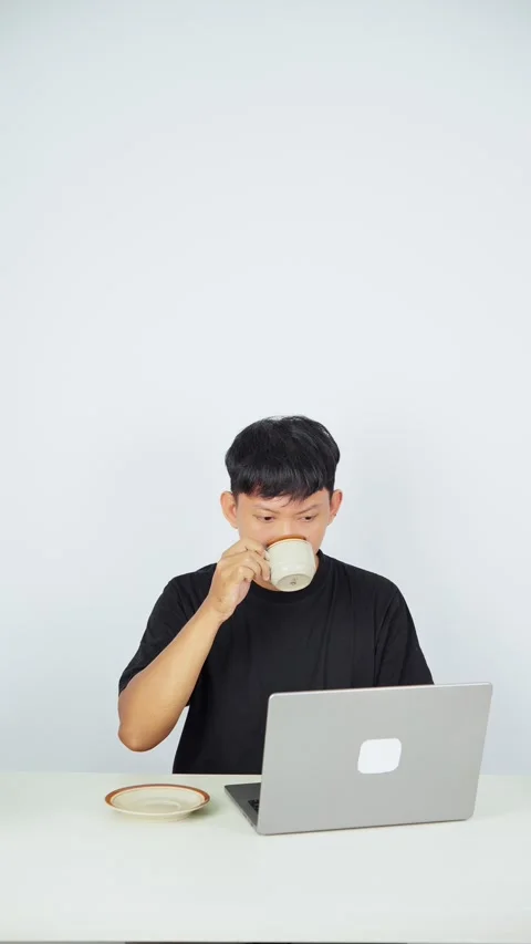Man Working on Laptop While Drinking Coffee Stock-Footage 347105436