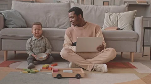 Man Working on Laptop while His Toddler Son Crying Stock Footage 171148901