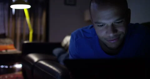 Man working late into the night from home. Shot on RED Epic. Dolly shot. Stock Footage 55216019