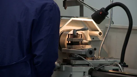 Man working at lathe metal machine rearview Видео 101043650