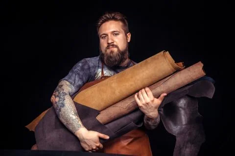 Man working with leather creates quality product of leather at the shop Stock Photos