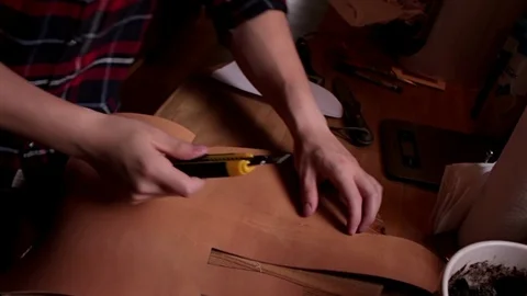 Man working with leather, Cutting a shape Stock Footage 91747434