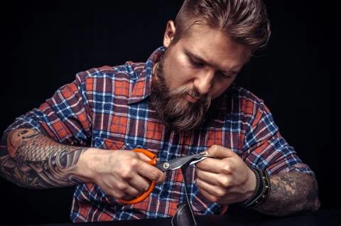 Man working with leather using crafting sciccors Stock Photos