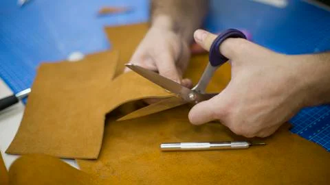 Man working with leather using crafting DIY tools Stock Photos