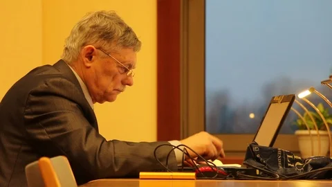 Man working in library, typing on laptop - editorial Stock Footage 99312929